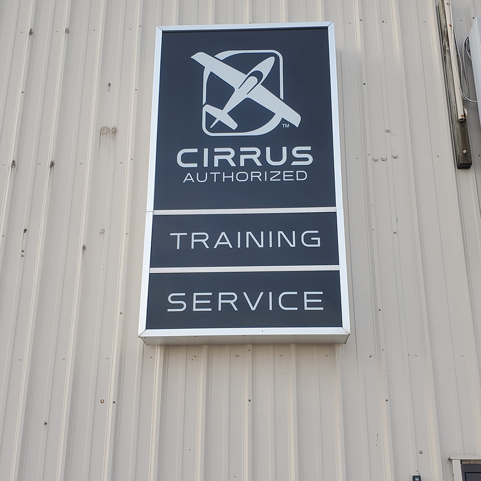 Cirrus Authorized Training and Service Center sign on the hangar at KLPR