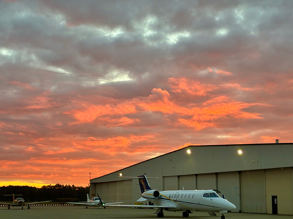 Private jet outside the MRK Aviation hangar at sunset
