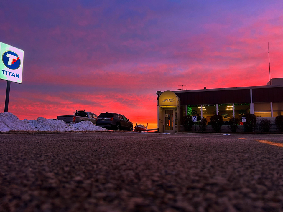 MRK Aviation building with Titan fuel sign at dusk in winter