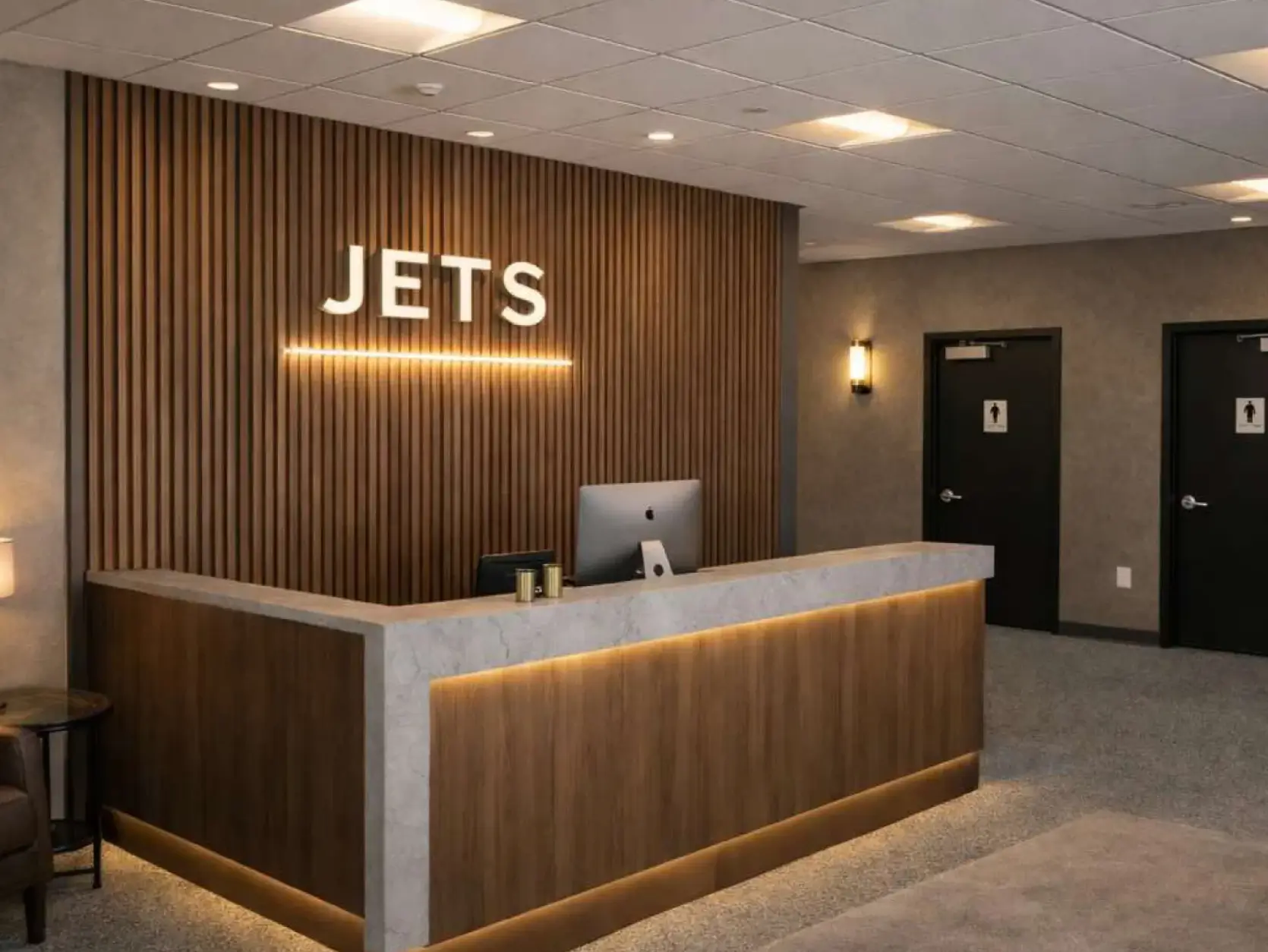 JETS reception desk with backlit JETS wordmark at South Hangar