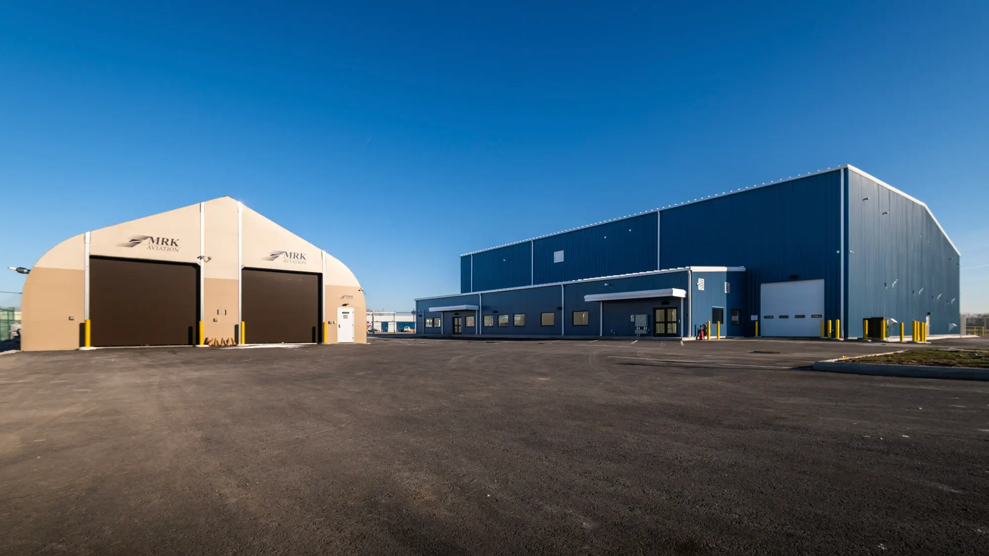 JETS South Hangar exterior with garage door access from Postal Road