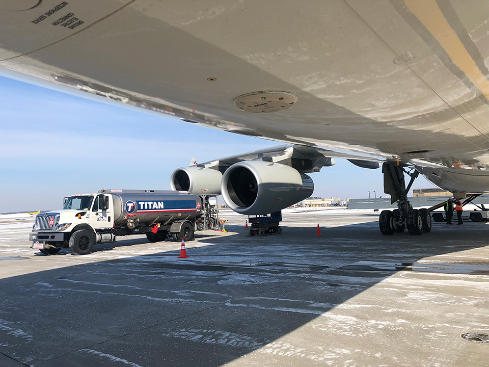JETS Titan fuel truck servicing a wide-body aircraft on the ramp at Youngstown in winter